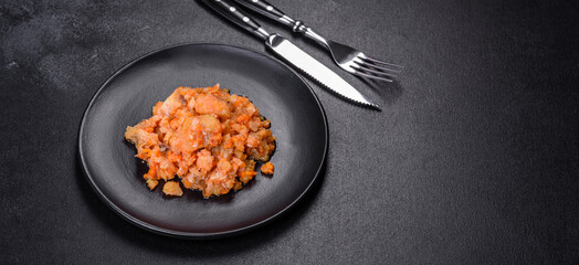 A delicious dish of hake fish in chunks in tomato sauce with spices and herbs