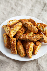 Homemade Italian Cantuccini with Almonds on a White Plate, side view. Crispy Almond Cookies.