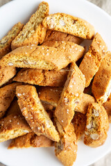 Homemade Italian Cantuccini with Almonds on a White Plate, top view. Crispy Almond Cookies. Flat lay, overhead, from above.