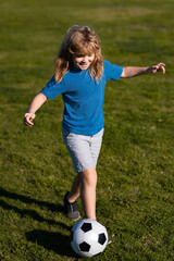 Soccer child play football. Concept of children sport. Cute boy in sport action. School football sports club.