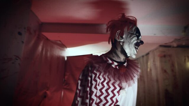 Scary clown maniac in his bloody lair