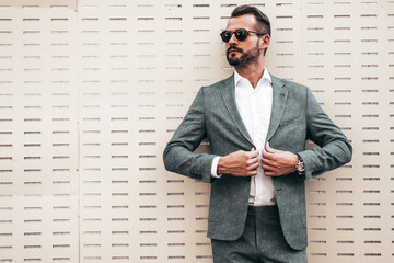 Portrait of handsome confident stylish hipster lambersexual model.Modern man dressed in elegant...