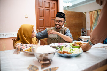 happy muslim father and daughter during iftar dinner on ramadan kareem