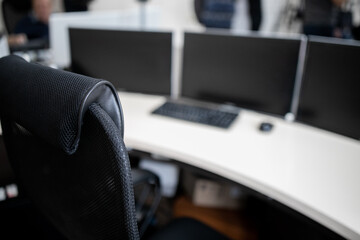 Professional Financial Data Analysts Working in a Modern Monitoring Office with Live Analytics Feed on a Big Digital Screen. Monitoring Room with Finance Specialists Sit in Front of Computers.