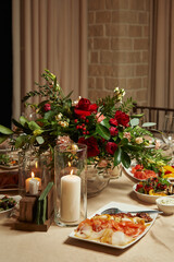 romantic dinner. the table is decorated with flowers and a burning candle in the restaurant.