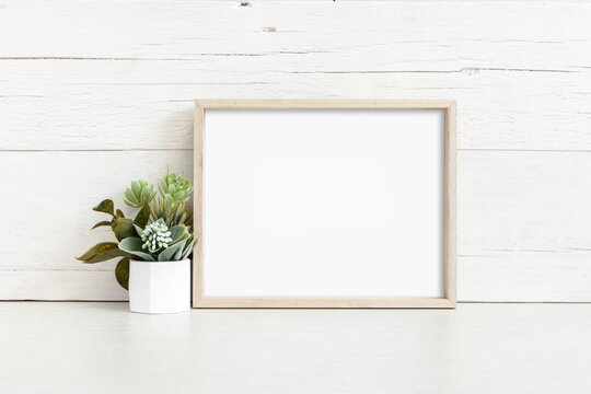 Mockup of a horizontal wooden frame on a light background