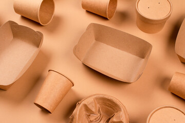 Eco-friendly tableware and kraft paper food packaging on kraft paper background - paper cups,...