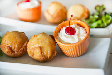 Close-up fried bakery dish with red cherry