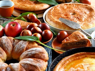 Easter food with eggs and homemade cakes on a wooden table.