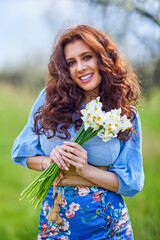 portrait of a beautiful brunette woman in spring nature.