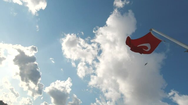 Turkish flag waving on the cloudy sky background on a flagpole. Turkish national days or holidays. Cumhuriyet bayrami or republic day and zafer bayrami or victory day 4K video.