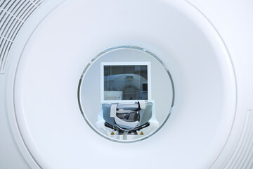 Bore view of modern MRI equipment with table and belts in clinic