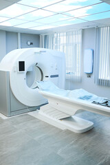 New MRI scan with long table covered with disposable sheet and digital display in hospital