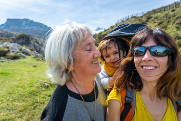Three generations on the path towards the lakes of Covadonga. Asturias. Spain
