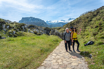 Obraz premium Three generations on the path towards the lakes of Covadonga. Asturias. Spain