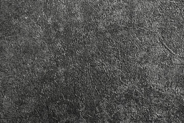 Gray background of decorative plaster with abstract spots. Unusual silver wall texture with beautiful patterns, creative surface background. Dressing coating for building cladding.