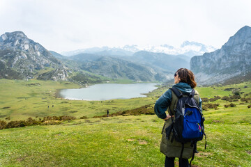 A young tourist with a backpack at the Entrelagos viewpoint of Lake Ercina in the Lakes of Covadonga. Asturias. Spain