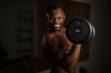 Attractive african american man smiling and doing exercise with dumbbells. 