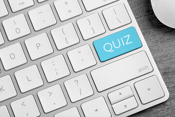 Turquoise button with word QUIZ on computer keyboard, closeup view