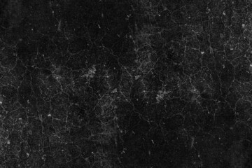 Cracked dark concrete plaster wall surface with heavy grunge texture for background