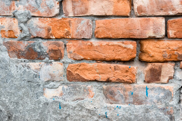 Aged broken brick structural concrete wall for background