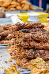 Fried chicken sticks on a street food market close up with selective focus