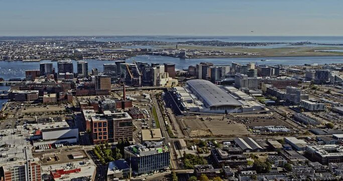 Boston Massachusetts Aerial v285 pan shot across former industrial neighbourhood towards financial district, capturing airplane take off at the airport - Shot with Inspire 2, X7 camera - October 2021