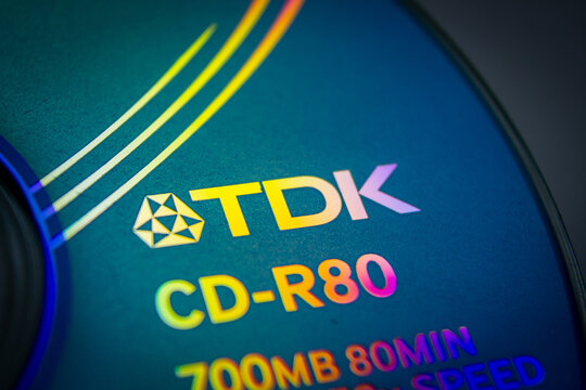 Sochi, Russia - April 21 2022: TDK company brand name and logo on surface of CD recordable optical disk. Memory storage system industry