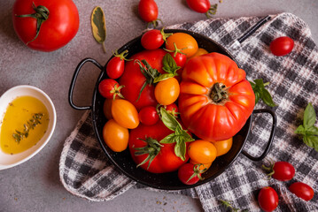 Various tomatoes served with basil. Healthy vegetable meal