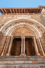 Entrance with doric columns, medieval tympanum of Church Eglise Saint-Pierre de Carennac, showing...