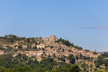 Medieval historic Lacoste village stands on hilltop of Little Luberon massif with ruins Marquis de Sade castle. Vaucluse, Provence, France