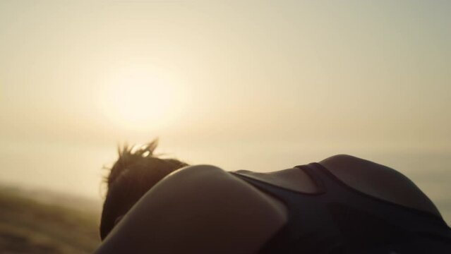 Silhouette girl making yoga asana att sunset light. Woman standing marjariasana.