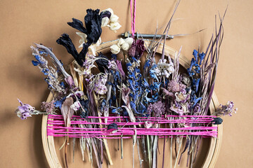 Dried Flower Decoration. DIY floral door wreath from colourful dry summer flowers.