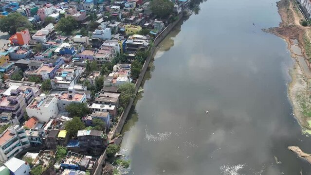 Aerial Footage of Cooum River Going Through Chennai City Slums shared by the wall.