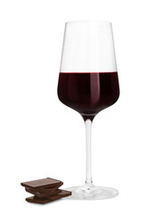 Glass of red wine and delicious chocolate pieces on white background