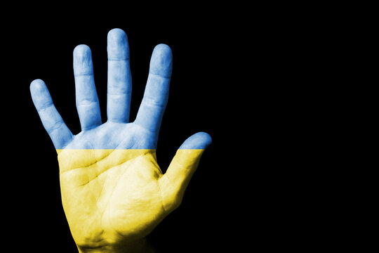 Stop the war background. Stop gesture open hand. Ukraine flag. Grunge industrial war background. Blue and yellow color country symbol. Palm hand isolated. Cutout on black. Support for Ukraine.