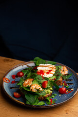 Buckwheat bread toasts with a poached egg, a sliced avocado, a shrimps, tomatoes and lettuce. Dietary menu. Flat lay.