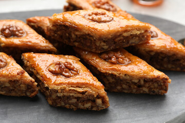 Delicious sweet baklava with walnuts on board, closeup