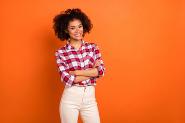 Photo of millennial curly lady crossed palms wear plaid shirt isolated on orange color background
