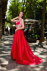 Fototapeta premium beautiful girl in a red dress on the street