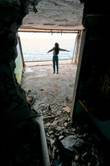 girls dream to fly over the sea and jump in ruined building