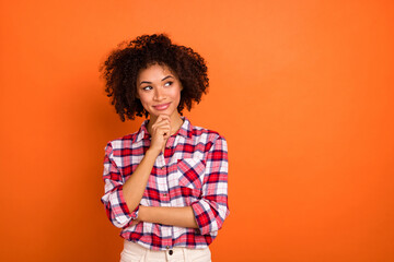 Photo of millennial curly lady hand face look promo wear plaid shirt isolated on orange color...