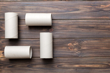 Flat lay composition with empty toilet paper rolls and space for text on color background. Recyclable paper tube with metal plug end made of kraft paper or cardboard