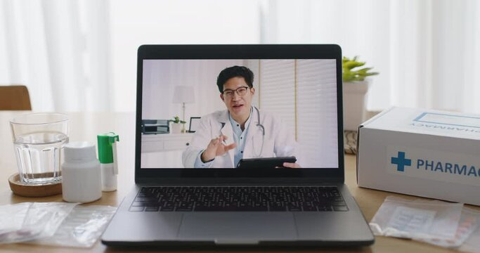 Video call screen of asia male doctor in teleconsult telehealth telemedicine app medtech platform chat advice first aid kit pill drug to sick patient at home. Help guide live talk in smart clinic.