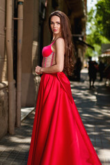 beautiful girl in a red dress on the street