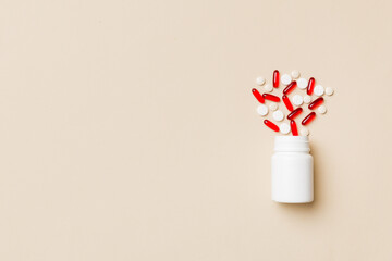 Multicolored pills and capsules in plastic bottle on Colored background, copy space. Many different...
