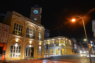 Fototapeta na wymiar PHUKET, THAILAND - March 21 2022: Old Police Station with Clock Tower (Left) and Phuket Museum (Right) Now Become the Landmarks of Chino Portuguese Building in Phuket Town.