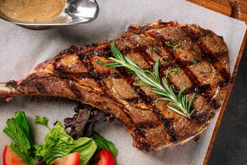 Top view on grilled beef steak with pepper sauce