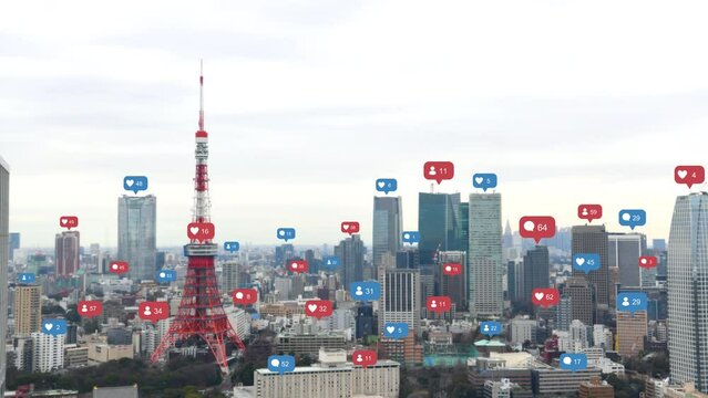 Aerial view of Tokyo cityscape with social media and notification icons pop up over the cities. Social media and Technology concept.