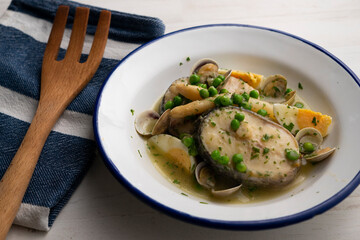 Basque hake with green sauce, asparagus, eggs and peas. Traditional Basque country tapas in the north of Spain.